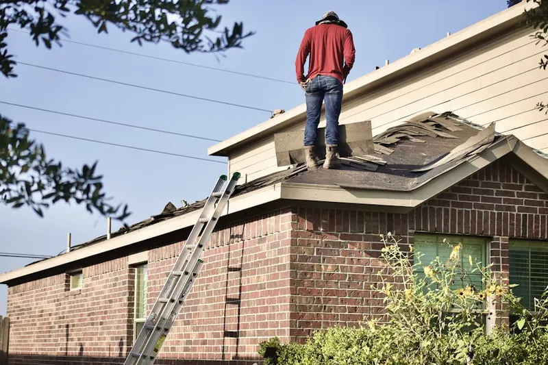 Professional roofer working on a residential roof in Little Chicago